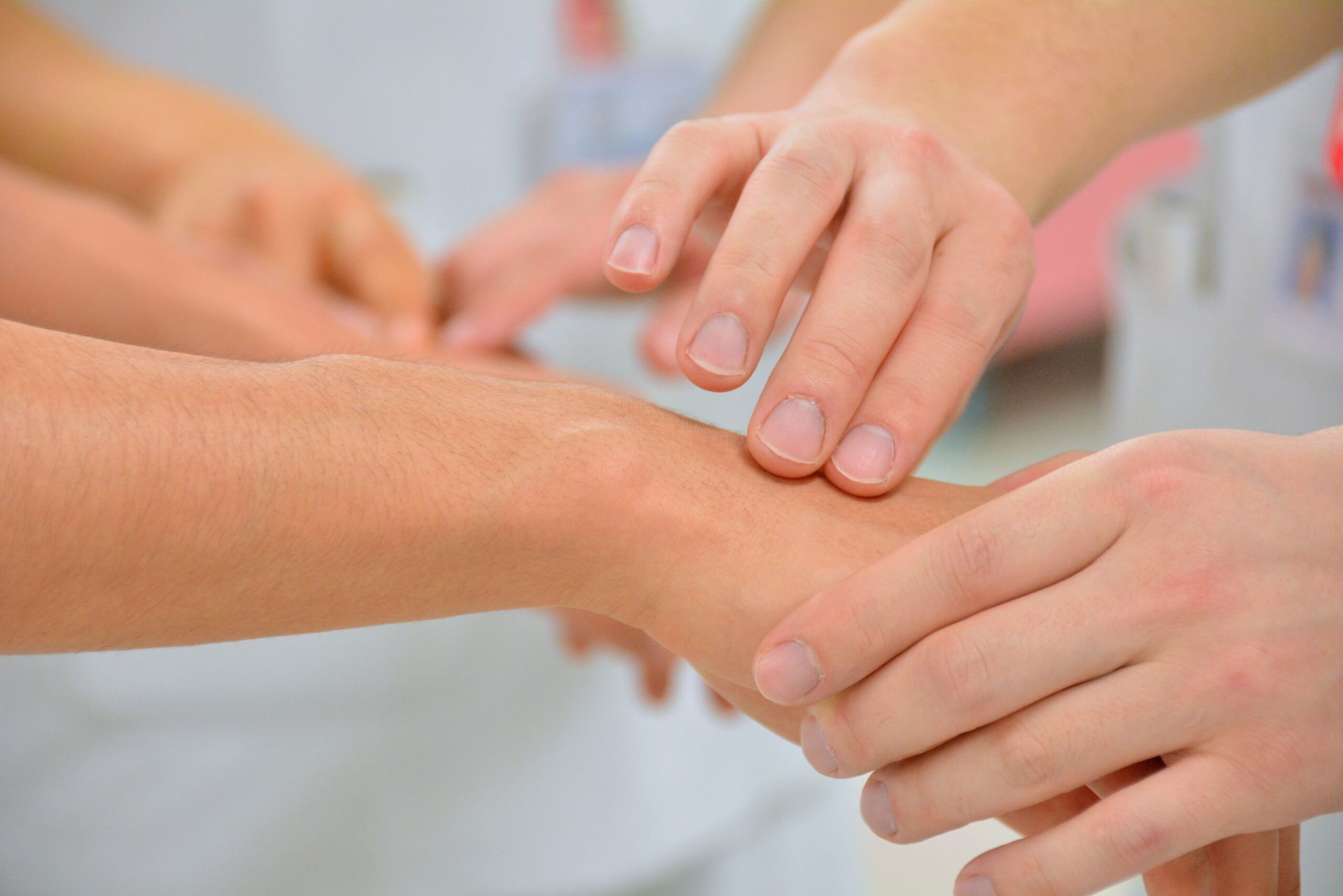 Close-up of several hands overlapping, symbolizing teamwork and support.